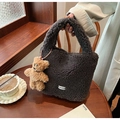 Detail of dark grey plush bucket bag with a cute brown bear charm and white clear label - Coffee (With Bear Pendant)