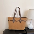 Brown suede tote bag with decorative leather straps and gold buckle in a minimalist setting - Khaki