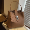 Brown lychee pattern bucket bag with cute dog pendant and adjustable strap - Brown