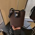 Dark brown suede bucket bag with black leather flap and silver circular metal buckle - Brown