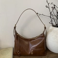 Close-up of vintage dark brown faux leather shoulder bag with textured oil-wax finish - Yellow Brown