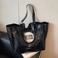 Large black PU leather tote bag featuring a white circular MOCO logo patch and long straps - Black