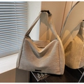 Macro detail of khaki tote bag showing textured twill fabric and premium buckle strap - Khaki