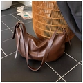 Detail of dark brown leather texture with adjustable strap and gold metal buckle on the bag - Brown