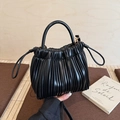Elegant black pleated bucket bag with cylindrical handle and adjustable shoulder strap - Black