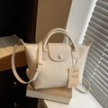 Chic beige woven texture crossbody bag with top handle and adjustable strap - Off White