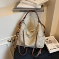 Beige vintage hobo bag with brown straps and tassel zippers on a black stool - Beige (With Pendant)