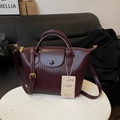 Elegant wine red woven leather crossbody handbag with golden zipper and top handle - Burgundy