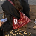 Glossy deep red patent leather hobo bag with gold zipper and wide shoulder strap - Red