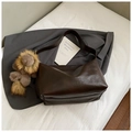 Detail of dark brown leather tote bag texture with cute plush animal charm on strap - With Pendant / Brown