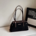 Detail view of black frosted tote bag with dark brown leather handles and side drawstrings - Black