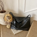 Classic black large capacity shoulder bag with a cute lion plush pendant on a rug - Black with Pendant