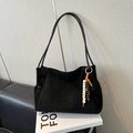 Minimalist black matte shoulder bag with beaded fringe tassel and embossed logo detail - Black With Pendant