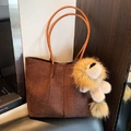 Deep brown woven texture tote bag with slim light brown straps and plush lion charm - With Charm / Brown