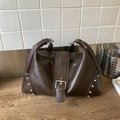 Vintage dark coffee crossbody tote bag with silver rivets and buckle on a wooden surface - Brown