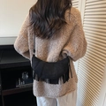 Black suede crescent bag with fringe tassels and knot strap detail shown on model - Black