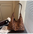 Detail of leopard print suede shoulder bag with brown strap and cloud charm accessory - Brown