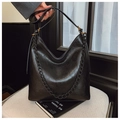 Macro shot of the black leather hobo bag texture with decorative resin chain detail - Black