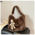 Detail of dark brown plush tote bag with furry texture and a cute puppy charm - Coffee with Pendant