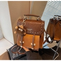Retro patchwork faux leather backpack in dark brown and caramel with plush monster charm - Brown with Pendant