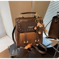 Retro dark brown leather backpack with contrast stitching and plush monster charm decoration - Coffee with Pendant