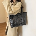 Quilted black puffer tote bag with glossy waterproof finish and shoulder straps - Black