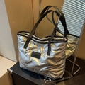 Silver metallic quilted puffer tote bag with black straps and fashion brand label - Silver