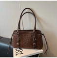 Detail der Wildledertasche mit Leopardenmuster, braunem Lederbesatz und Silberschnallen - Leopardenmuster