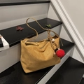 Brown faux suede dumpling tote bag with red pompom charm and ethnic bead detail - With Charm / Brown