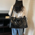 Black large capacity travel tote in shiny PU leather with adjustable shoulder strap - Black