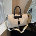 Cream woven travel bag with black leather handles and adjustable shoulder strap - Off White
