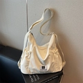 Borsa a tracolla plissettata color crema con etichetta Myron Bear e tracolla regolabile - Bianco Sporco