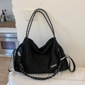 Large black canvas tote bag featuring stylish black and white striped woven handles - Black