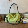Bright green nylon shoulder bag with black and white woven rope strap and FASHION tag - Green