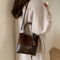 Deep brown patchwork crossbody bucket bag in matte suede and polished leather - Coffee with Pendant