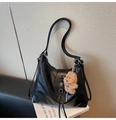 Detail of black leather hobo bag with floral metal buckle and plush bear pendant - With Pendant / Black