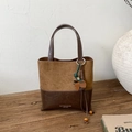 Detail view of leopard print suede bucket bag with leather base and brand logo - Brown with Pendant