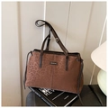 Detail view of leopard print tote bag with brown leather handles and brand logo - Leopard Coffee