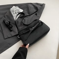 Minimalist black leather shoulder bag with pleated texture and silver buckle detail - Black