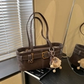 Retro dark brown suede bucket bag with white stitching and plush lion charm - With Charm / Brown