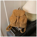 Close-up of khaki vintage backpack featuring buckle straps and matte suede texture - Brown