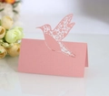 Detail of laser-cut hummingbird place card in pearl pink for wedding table decor - Pink