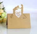 Close-up of golden glitter Mr & Mrs wedding place card with laser-cut bridal silhouette - Beige Gold