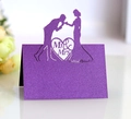 Close-up of purple glitter wedding place card with laser cut Mr & Mrs heart silhouette - Deep purple