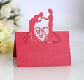 Macro view of laser-cut red pearlescent wedding place card with Mr & Mrs silhouette - Pearlescent Red