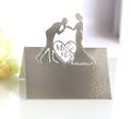 Close-up of silver laser-cut wedding place card featuring Mr & Mrs heart silhouette - Reflective Silver