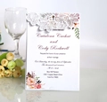 Detail view of laser-cut rose hollow invitation with elegant floral lining and script font - White