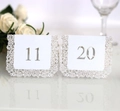 Detail of laser-cut wedding table cards with white lace floral pattern and hollow numbers - White Numbers 11-20