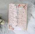 Detail of laser-cut rose invitation card with pink cardstock and floral inner paper - Pink