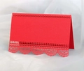 Close-up of red laser-cut place card featuring intricate lace hollowed patterns and texture - Pearlescent Red